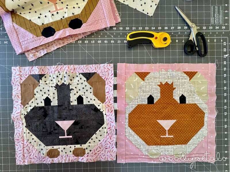 Fabric animal face quilt blocks with pink and brown fabrics on cutting mat