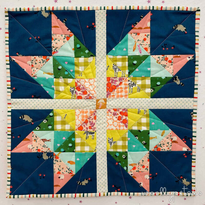 Woollypetals Starfy quilt in navy, coral, green, and yellow fabrics
