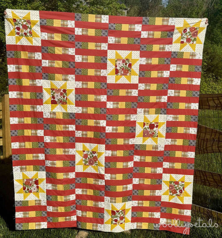 Woollypetals StarBeam quilt in red, yellow, white and green fabrics