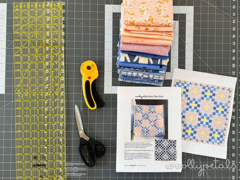 Woollypetals New Star Beginner Quilt Course fabric prep with ruler, rotary cutter, scissors, and fabric stack