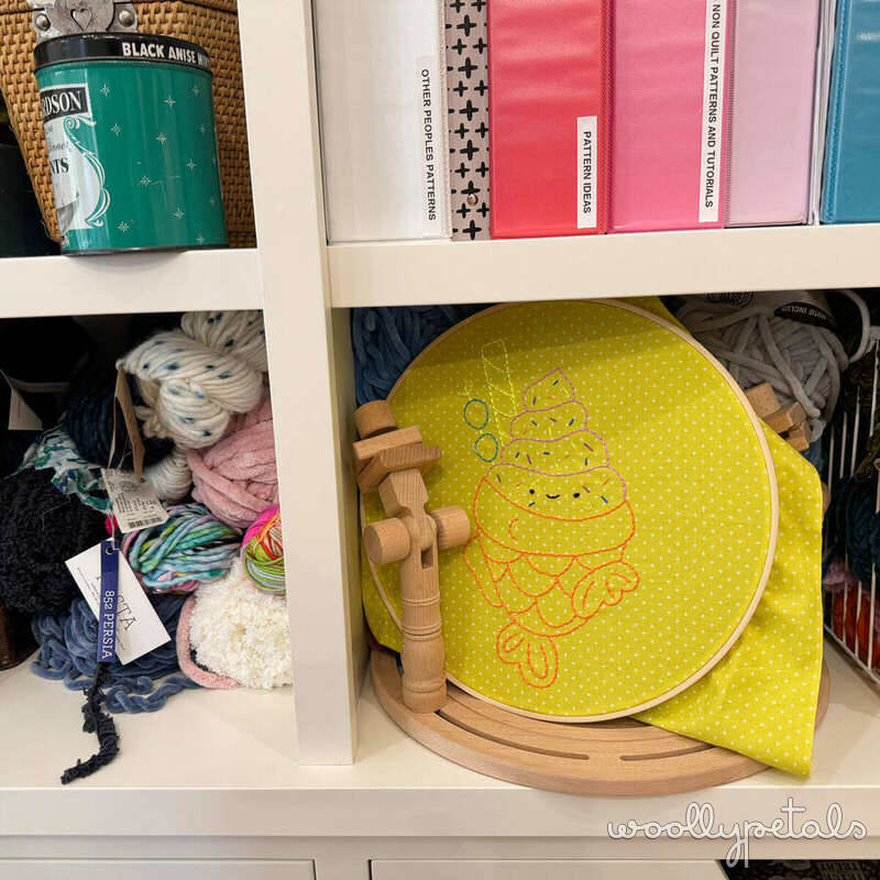 Bright yellow embroidery hoop with Christmas tree design and wooden stand