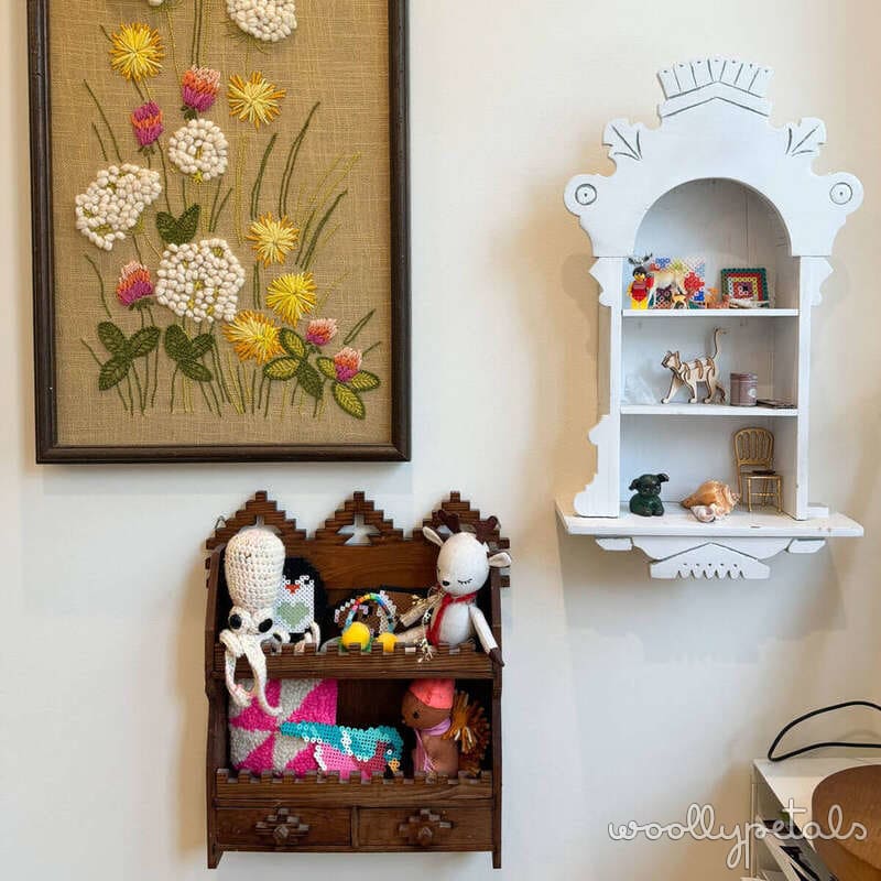 Sewing room wall decor with embroidered flower art and wooden shelving units