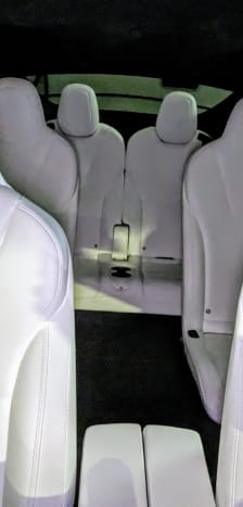 The interior of a car with white leather seats