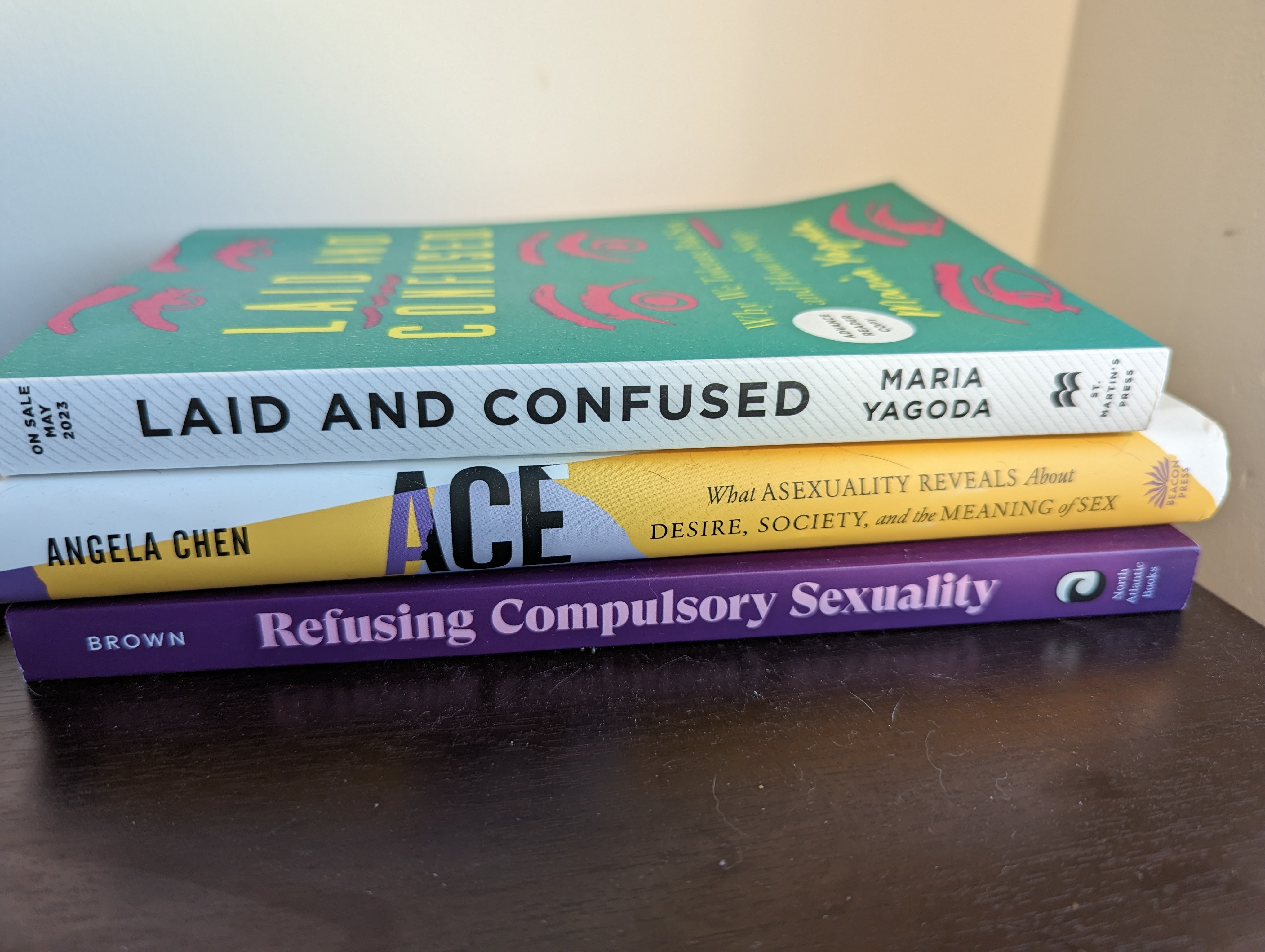 A stack of the books Laid and Confused, Ace, and Refusing Compulsory Sexuality