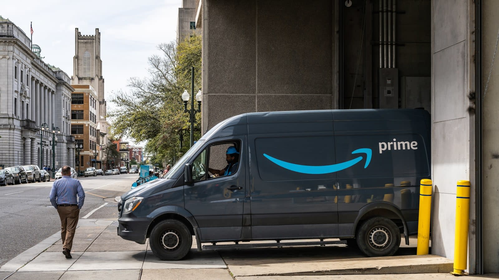 Furgoneta de reparto de Amazon Prime aparcada junto a un muelle de carga en una calle de Nueva Orleans