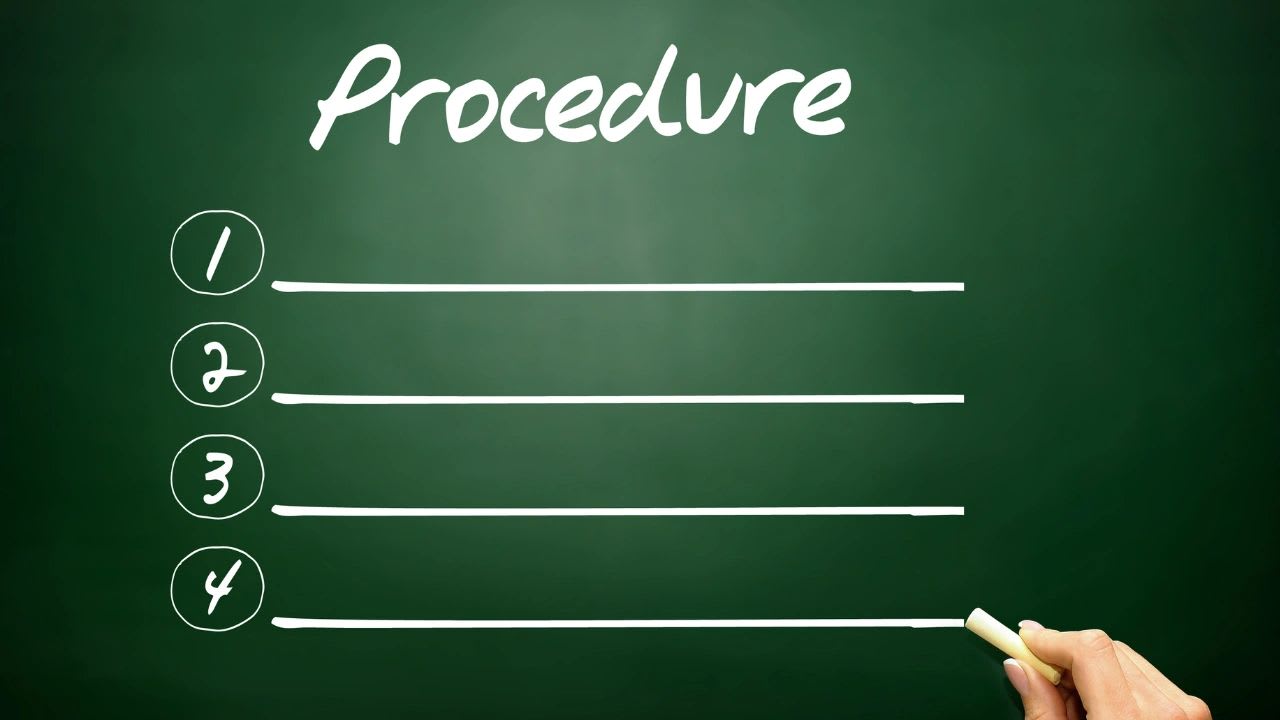Small business owner writing standard operating procedures