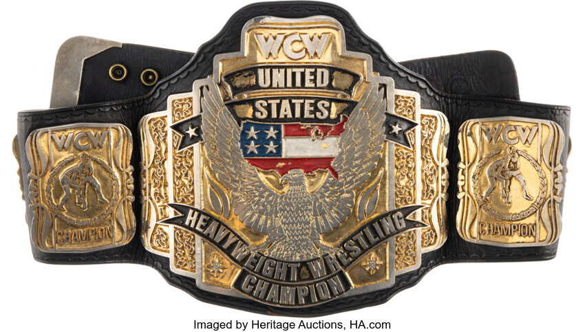 Main front view of event-worn 1990s WCW United States Heavyweight Championship belt showing central eagle plate and full WCW iconography, won by Steve Austin, Ricky Steamboat, Lex Luger and Sting