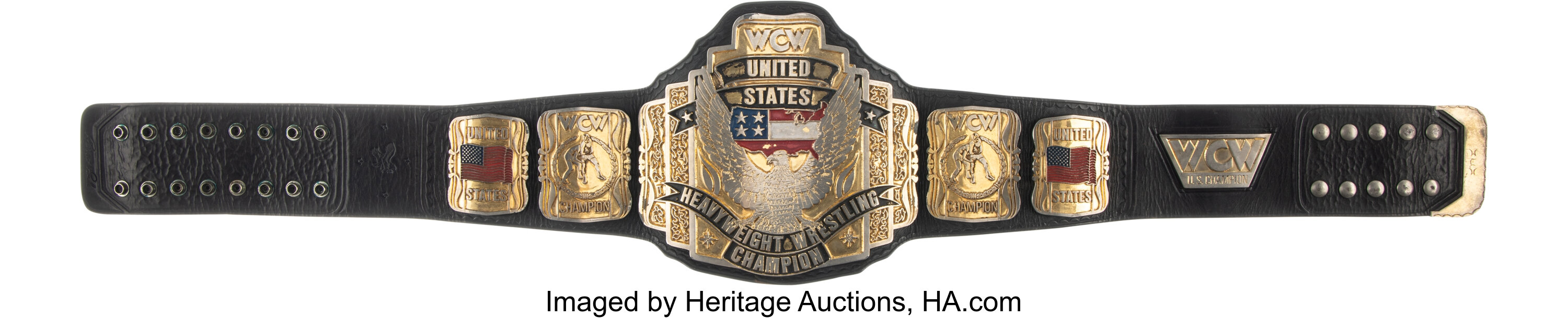 Close-up of center plate and mounting rivets on the WCW United States Heavyweight Championship belt showing engraved United States motifs, surface patina and fine detail