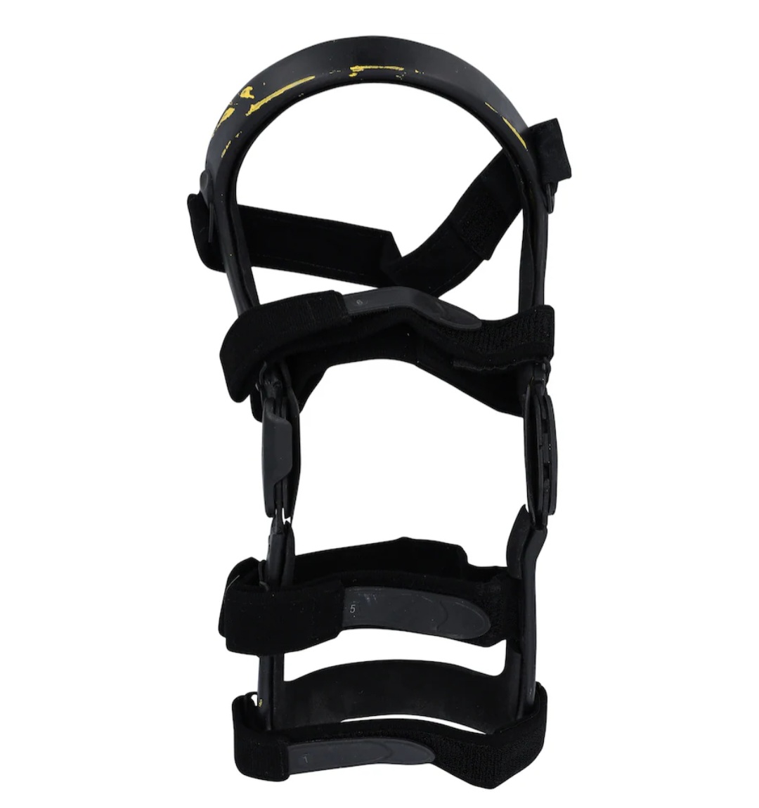 Side profile view of authentic event-worn Stone Cold Steve Austin WrestleMania 38 right knee brace highlighting contour and hinge area
