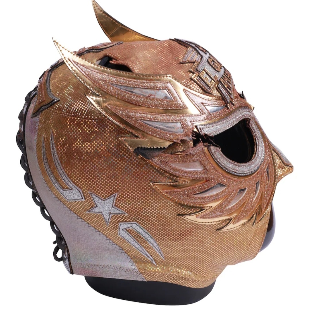 Right side profile of the autographed El Grande Americano mask highlighting stitched seams and match use from the Mascara vs. Mascara bout against Ludwig Kaiser