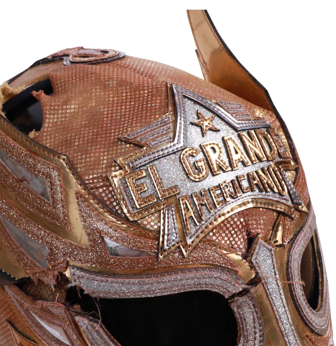 Angled front detail of the El Grande Americano match-worn mask showing full face design, colors and event wear from the May 30 2026 Noche de Los Grandes
