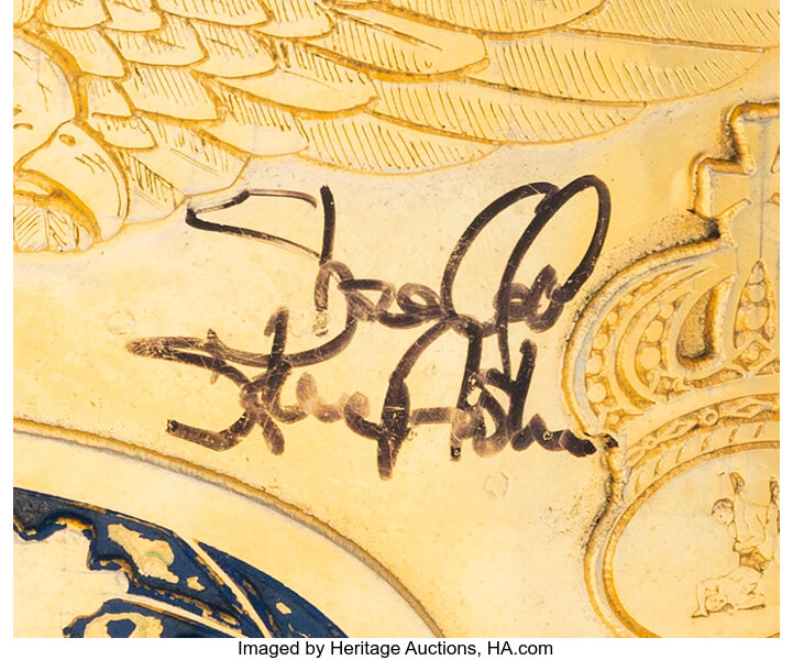 Close up of center plate with bold black felt tip signature by Stone Cold Steve Austin showing enamel chipping and Reggie Parks details