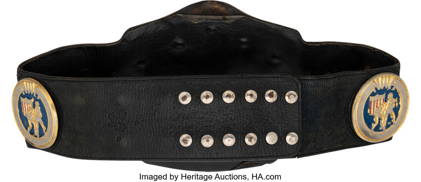 Close-up alternate angle highlighting the center plate and side-plate details, leather strap wear and TV-era damage associated with Nikita Koloff, noted Heritage auction provenance and historical United States Heavyweight Championship title belt