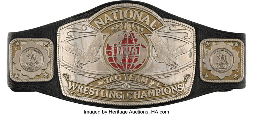 Main front view of 1984-85 NWA Tag Team Title held by Arn & Ole Anderson showing full engraved center plates and original leather strap, event-worn wrestling belt from Heritage Auctions sold for $30,500 on 8/22/2026