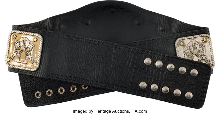 Close-up alternate view of the 1984-85 NWA Tag Team Championship highlighting side plates, strap wear and inscription details tied to Arn & Ole Anderson, provenance from Heritage Auctions sale $30,500 8/22/2026