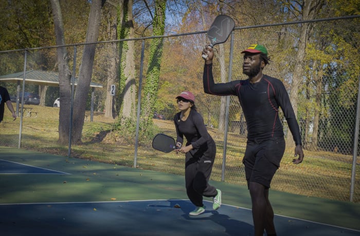 Two Bouncecraft players celebrating a point with paddles raised