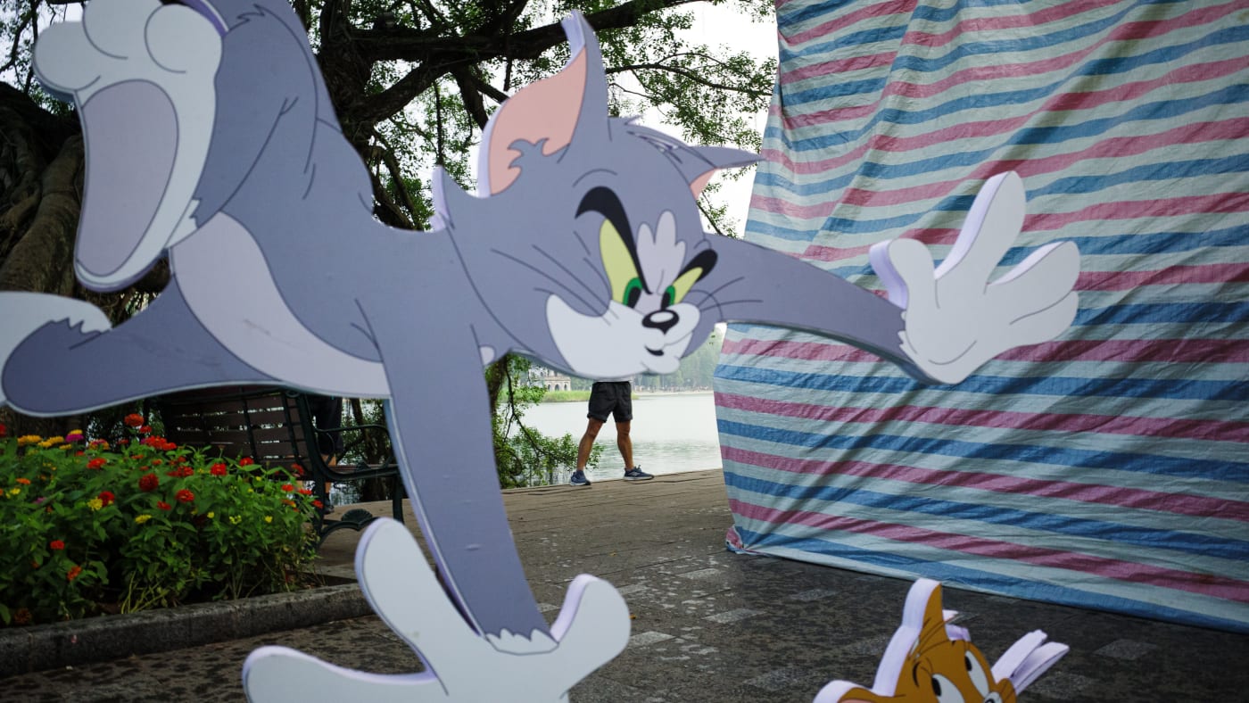 Tom and Jerry cutouts with person walking behind — Le Hoang Tuan