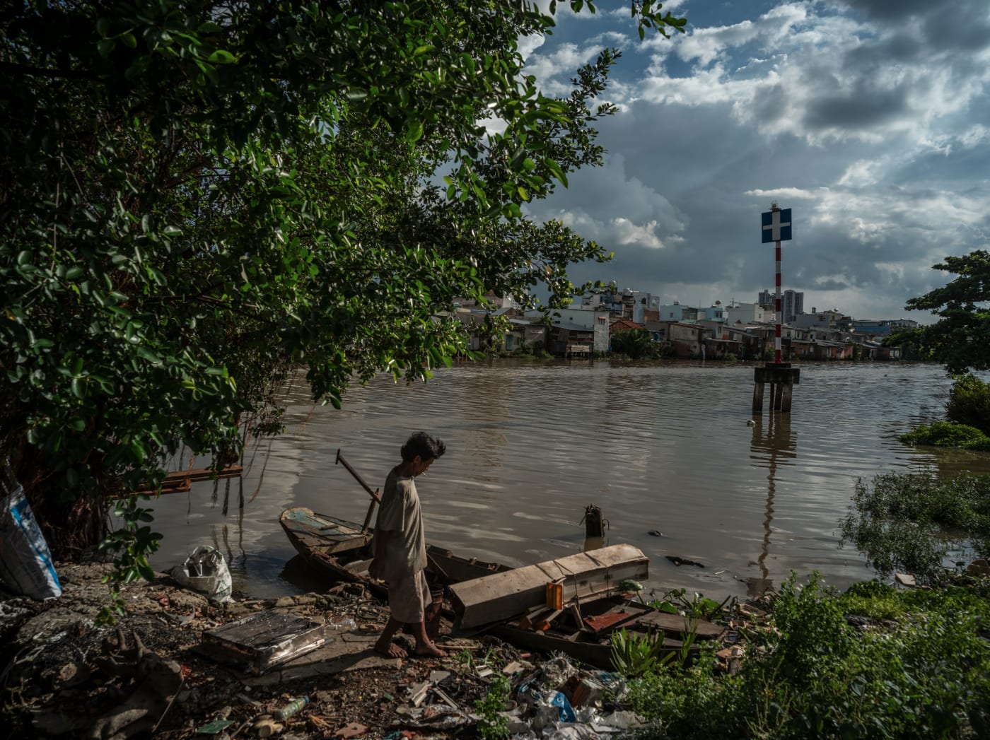 Resident walking along the canal bank in District 8 — Alexandre Garel