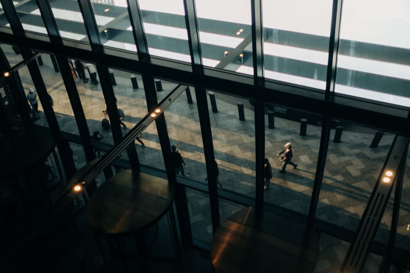 Commuters seen from above through the sloping glass wall of a Chicago atrium