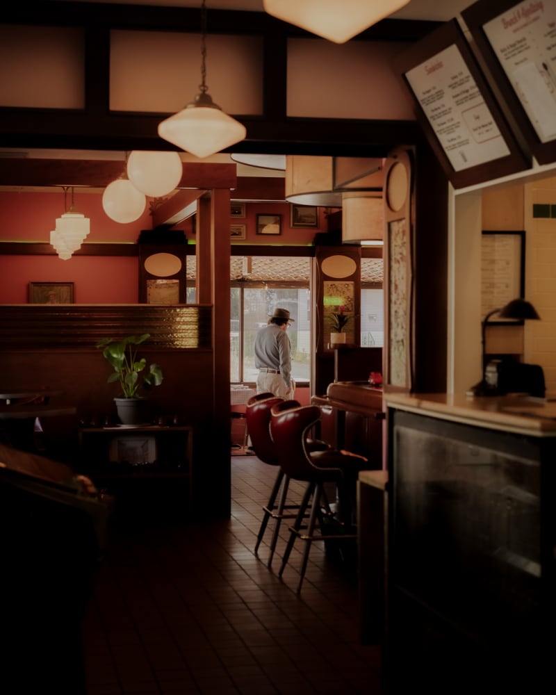 Warm interior of a Madison bar, pendant lights hanging over an empty wooden counter
