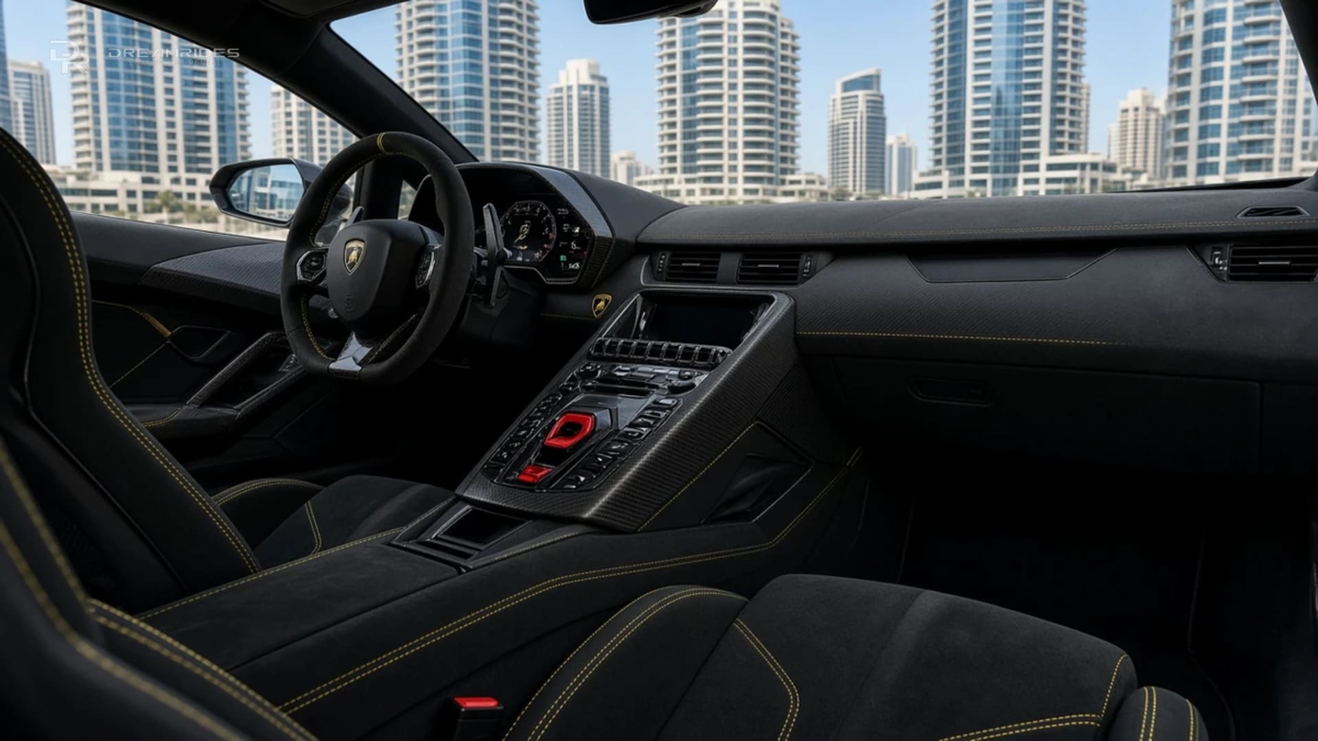 Lamborghini Aventador SVJ cockpit in daylight with Alcantara seats, yellow stitching, a red flip-up start-button cover, and Dubai Marina towers through the windscreen