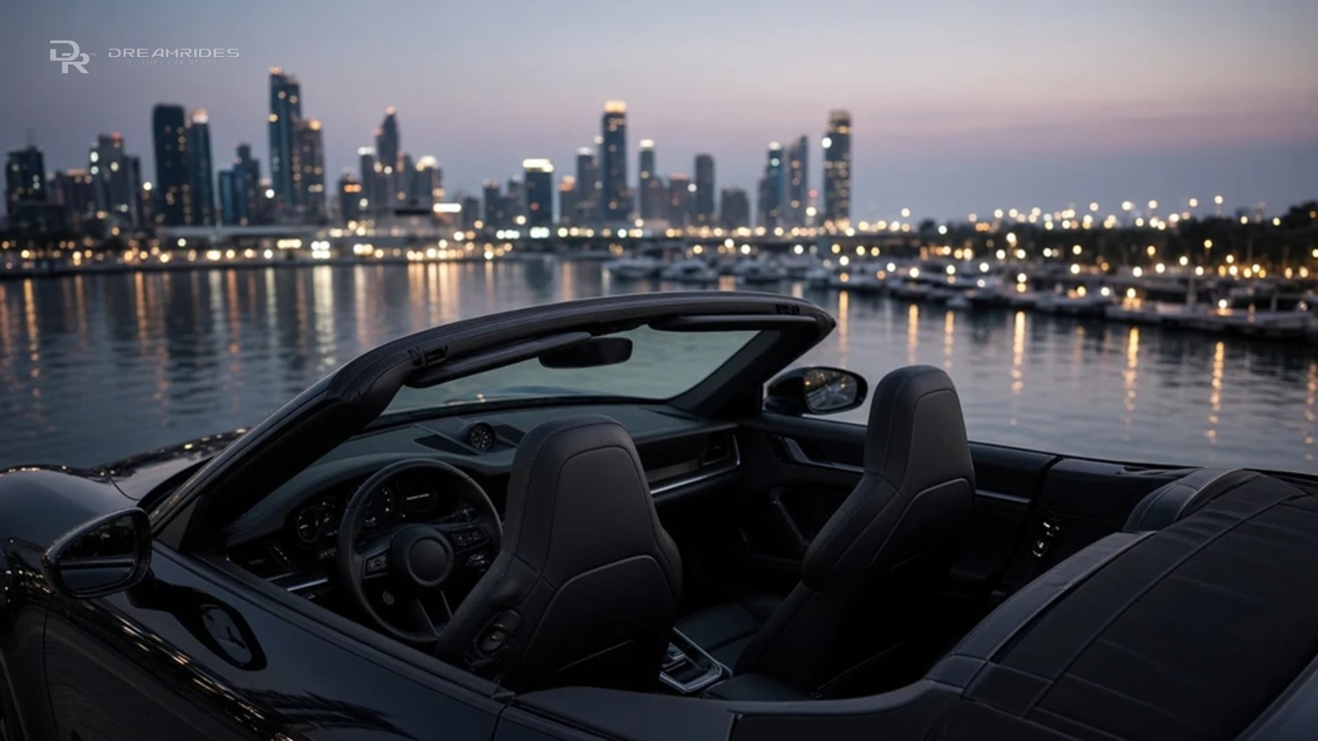 Porsche 911 Turbo S Cabriolet cockpit with roof open, sport seats, and a digital cluster facing a cool winter Marina skyline at dusk
