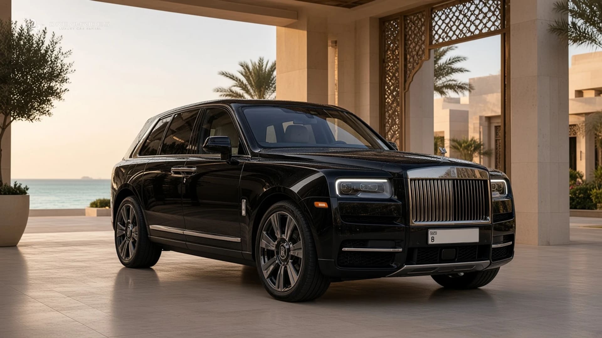 Best luxury car to rent on Bulgari Island Dubai: a Rolls-Royce Cullinan at a pale-stone island resort porte-cochère in soft morning light, with calm sea beyond the columns