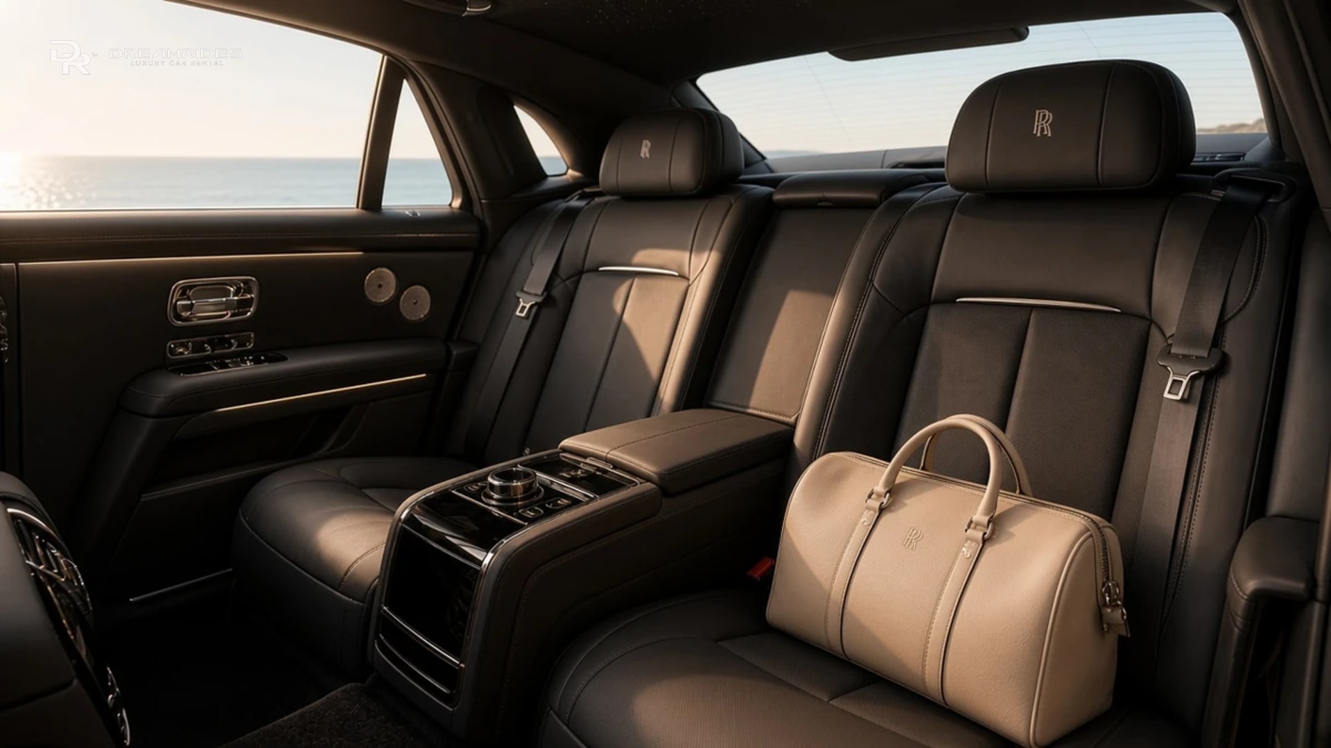 Rolls-Royce Ghost Series II rear cabin in warm morning light, with one leather weekender on the seat