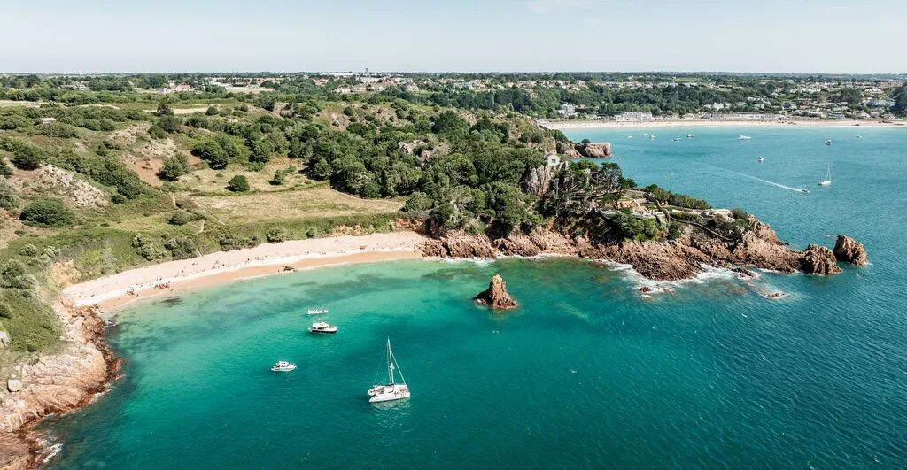 An aerial shot with Beauport in the foreground and St.Brelade's Bay in the background