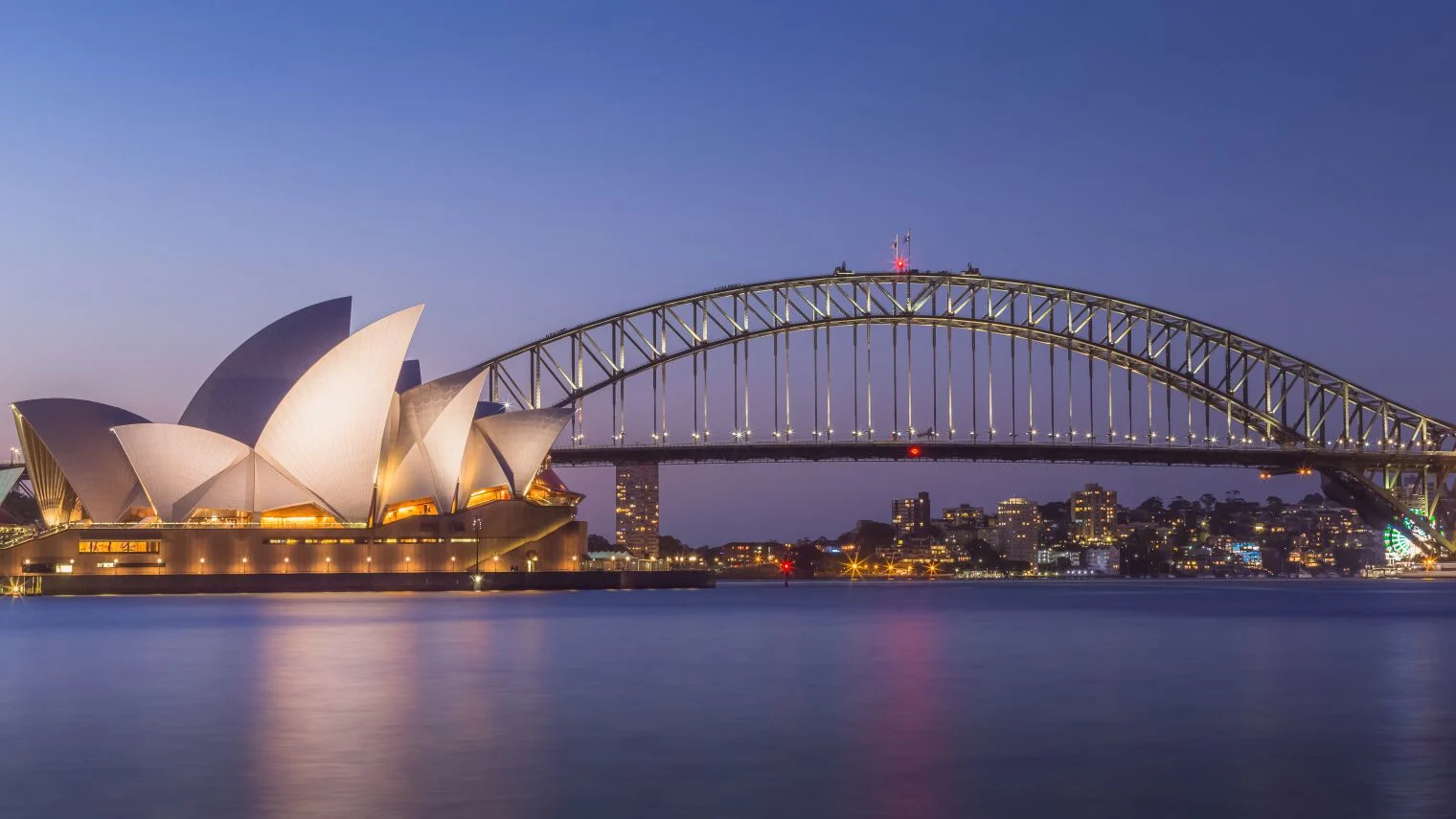 Summer evening twilight panoramic view of the iconic Sydney Opera House and Harbour Bridge