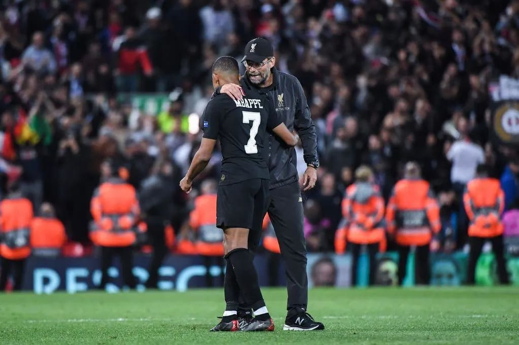 Kylian Mbappé greets Jürgen Klopp at Anfield during Liverpool's Champions League match against PSG