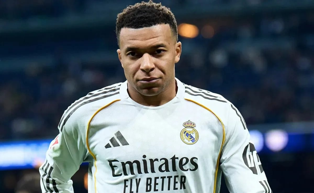 Kylian Mbappé wearing a Real Madrid shirt during a match, looking down