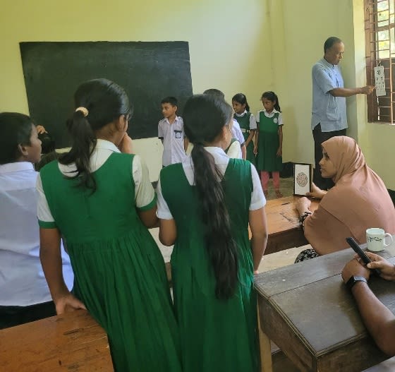 Schoolgirls wait their turn for an eye check.