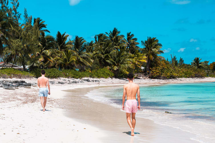 An image of a travel engaged in walking in a beach.