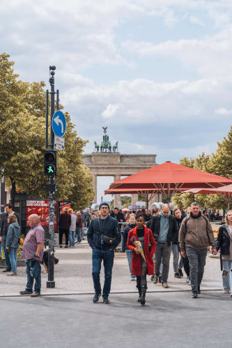 An image of a street and travel engaged in walking in a city.