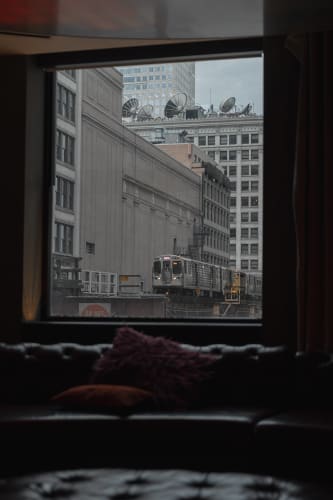 An image of a cityscape and architecture engaged in reading in a morning with a introspective atmosphere.