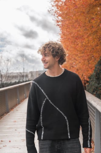 An image of a urban and self-portrait engaged in music in an outdoor setting.