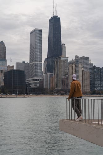 An image of a cityscape and urban engaged in walking in a landmark with a introspective atmosphere.