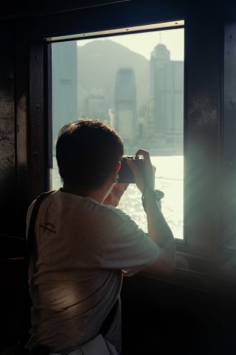 An image of a travel and self-portrait engaged in reading in a morning.