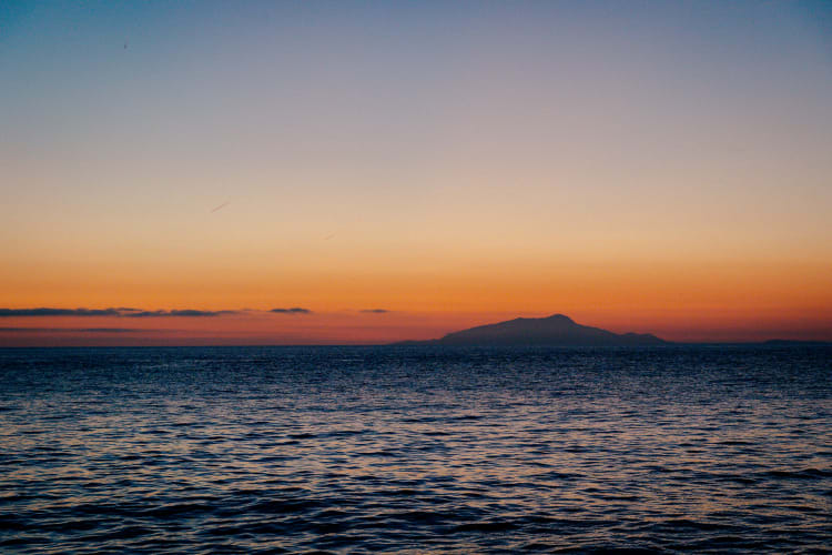 An image of a landscape in a sunset.