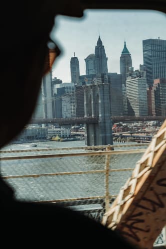 An image of a urban and cityscape engaged in reading with a introspective atmosphere.