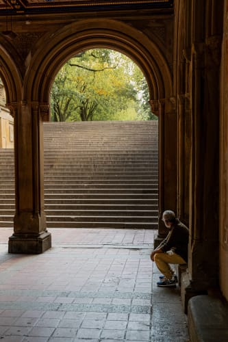 An image of a travel and architecture engaged in reading with a introspective atmosphere.