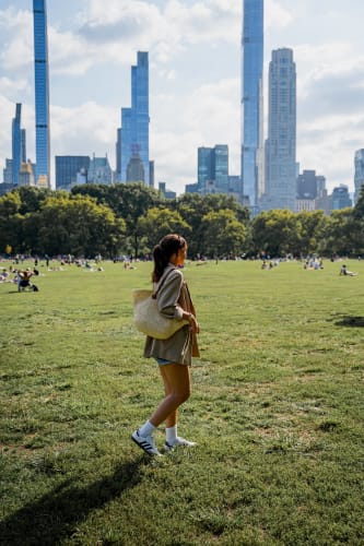 An image of a cityscape and travel engaged in walking in a park.