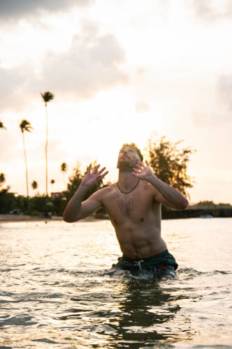 An image of a travel engaged in dancing in a beach.