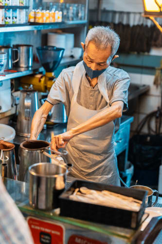 An image of a food engaged in cooking in a cafe.