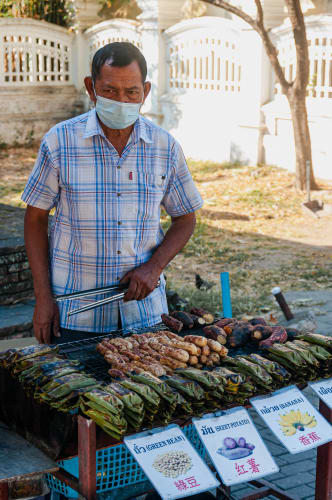 An image of a food engaged in cooking in a cultural site.