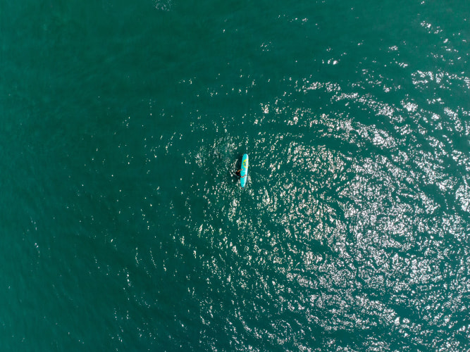 An image of a travel engaged in walking in a beach with a calm and serene feel.
