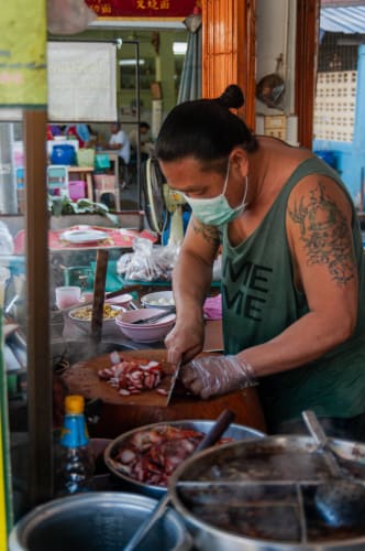 An image of a food and travel engaged in cooking.