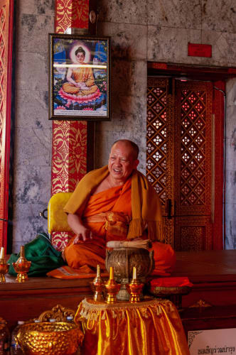 An image of a travel engaged in reading in a cultural site with a happy and joyful feel.