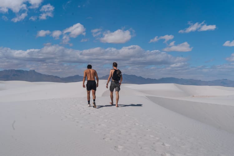 An image of a travel and landscape engaged in walking in a beach.